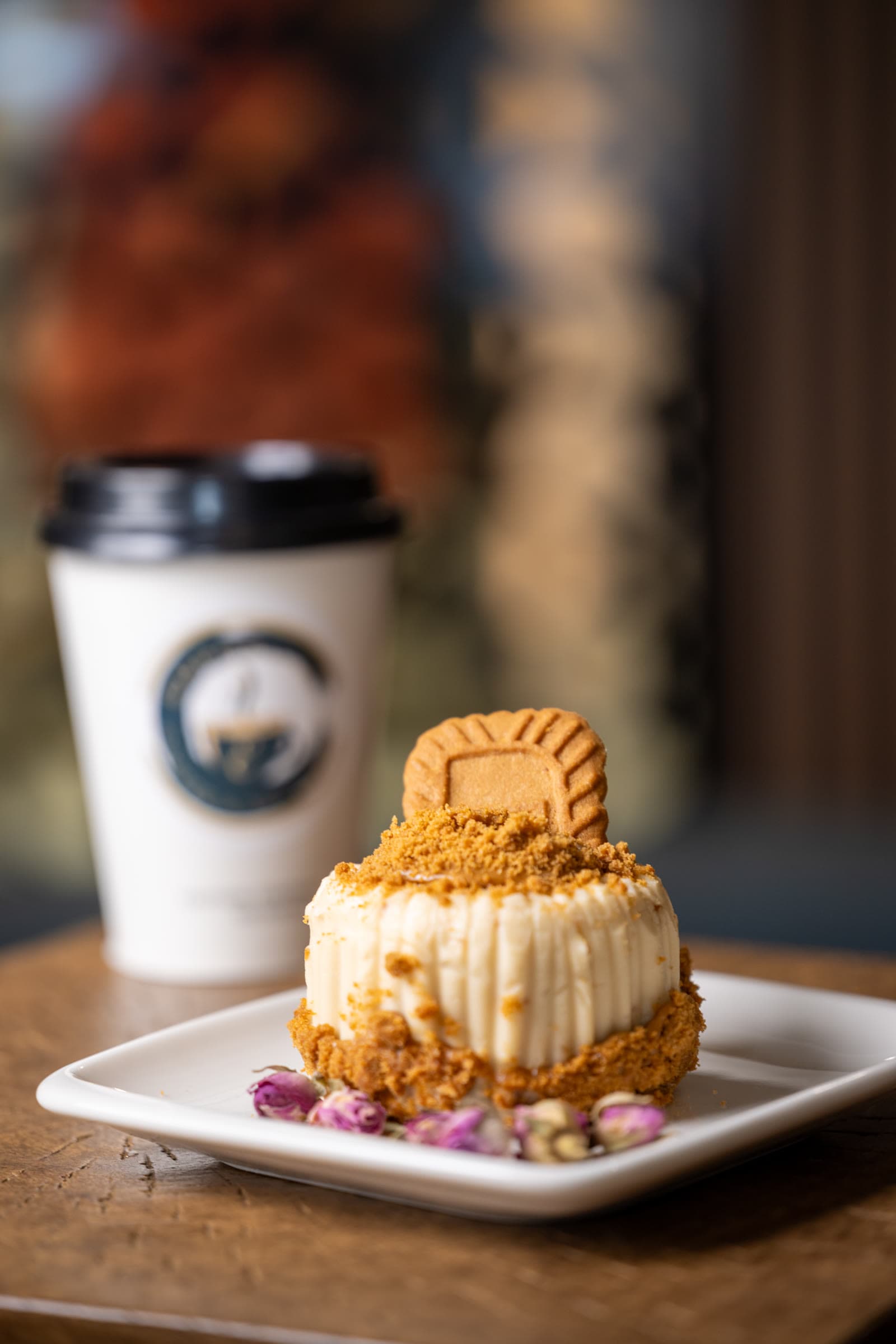 Biscoff mini cake beside a branded Emporium to-go cup