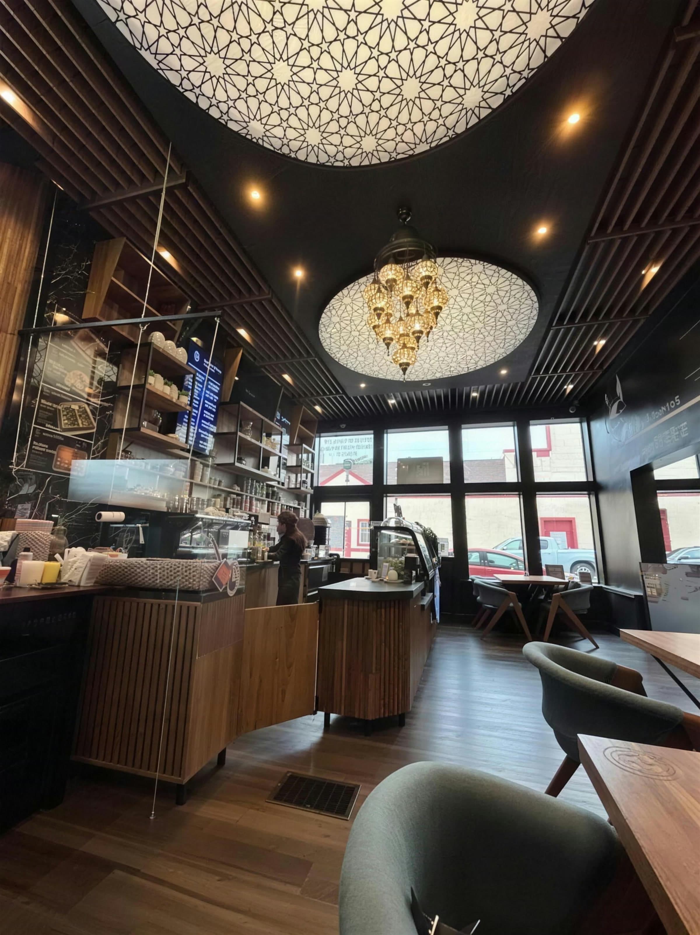 Hand-carved geometric star ceiling medallion above the espresso bar